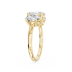 Three oval shaped lab diamonds sit across a polished yellow gold band with graduated sizes and individual prong settings