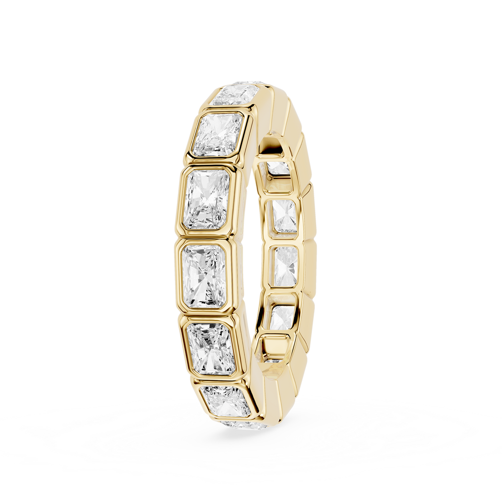 A yellow gold eternity ring featuring a continuous row of baguette-cut clear gemstones in a bezel setting, shown on a plain white background.