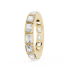 A yellow gold eternity ring featuring a continuous row of baguette-cut clear gemstones in a bezel setting, shown on a plain white background.