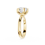 Gold ring with a clear gemstone on a white background