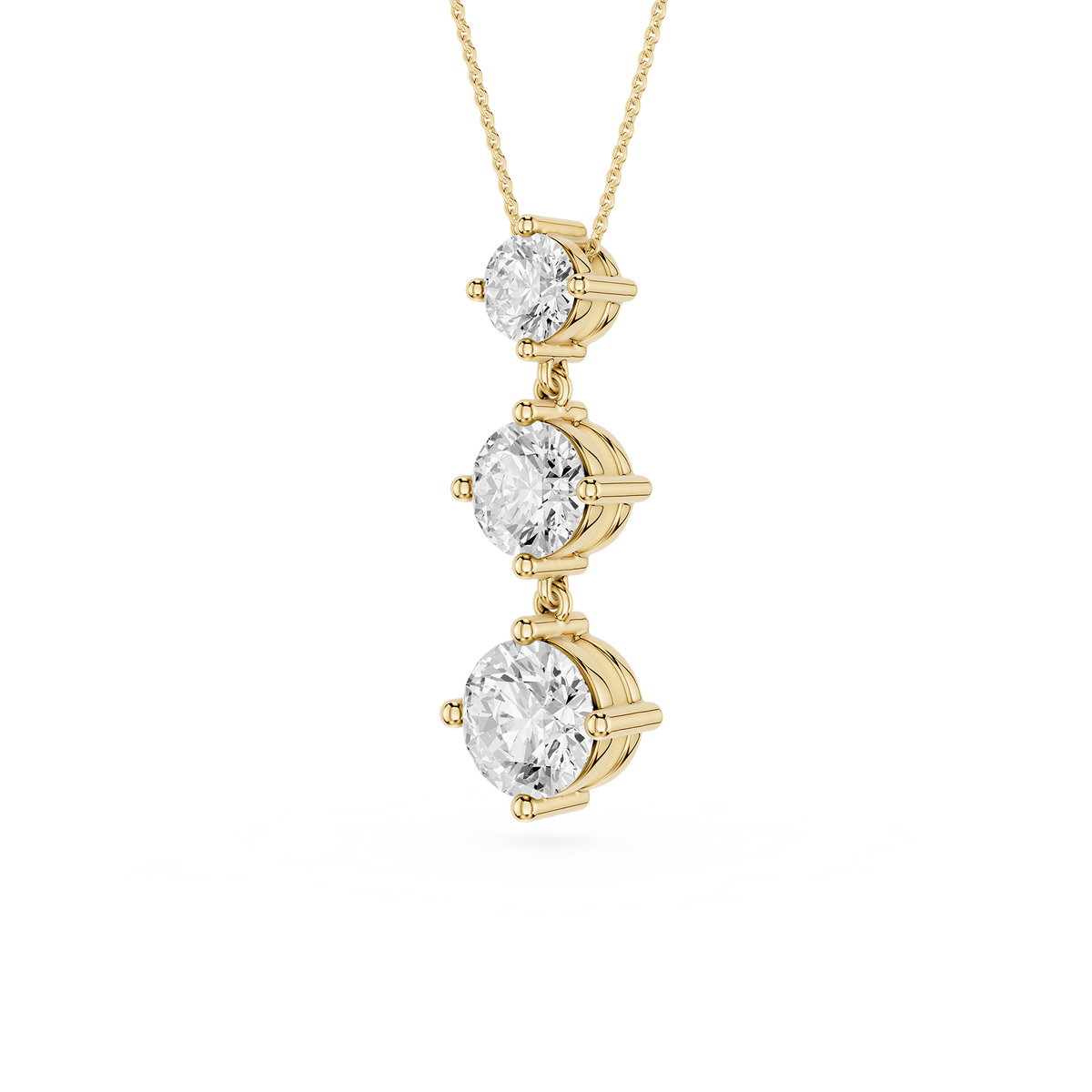 Gold necklace with three diamond pendants on a white background