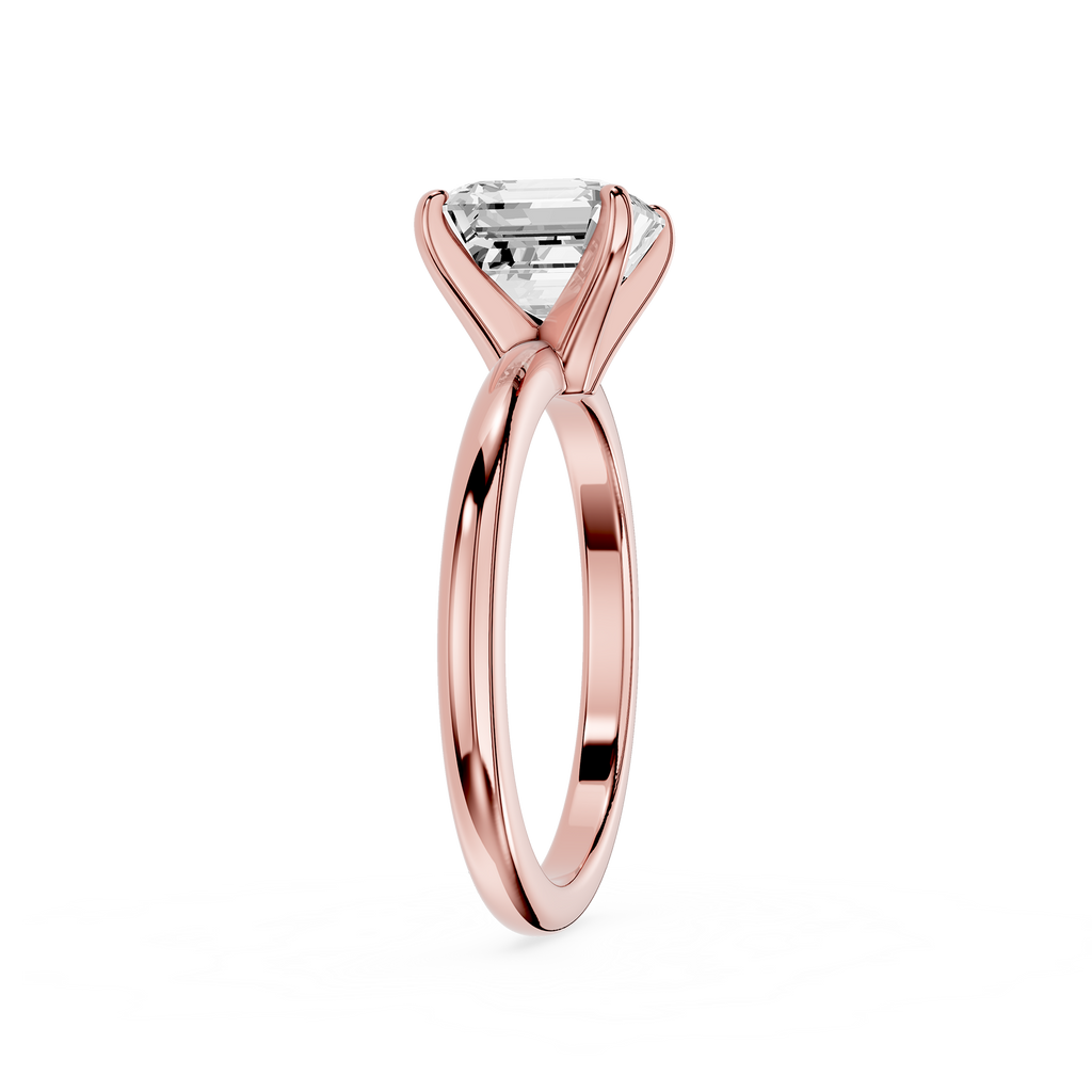 Rose gold ring with a clear gemstone on a white background