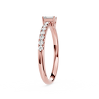 Rose gold ring with diamonds on a white background