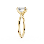 Gold ring with a diamond on a white background