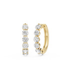 Gold hoop earrings with clear gemstones on a white background