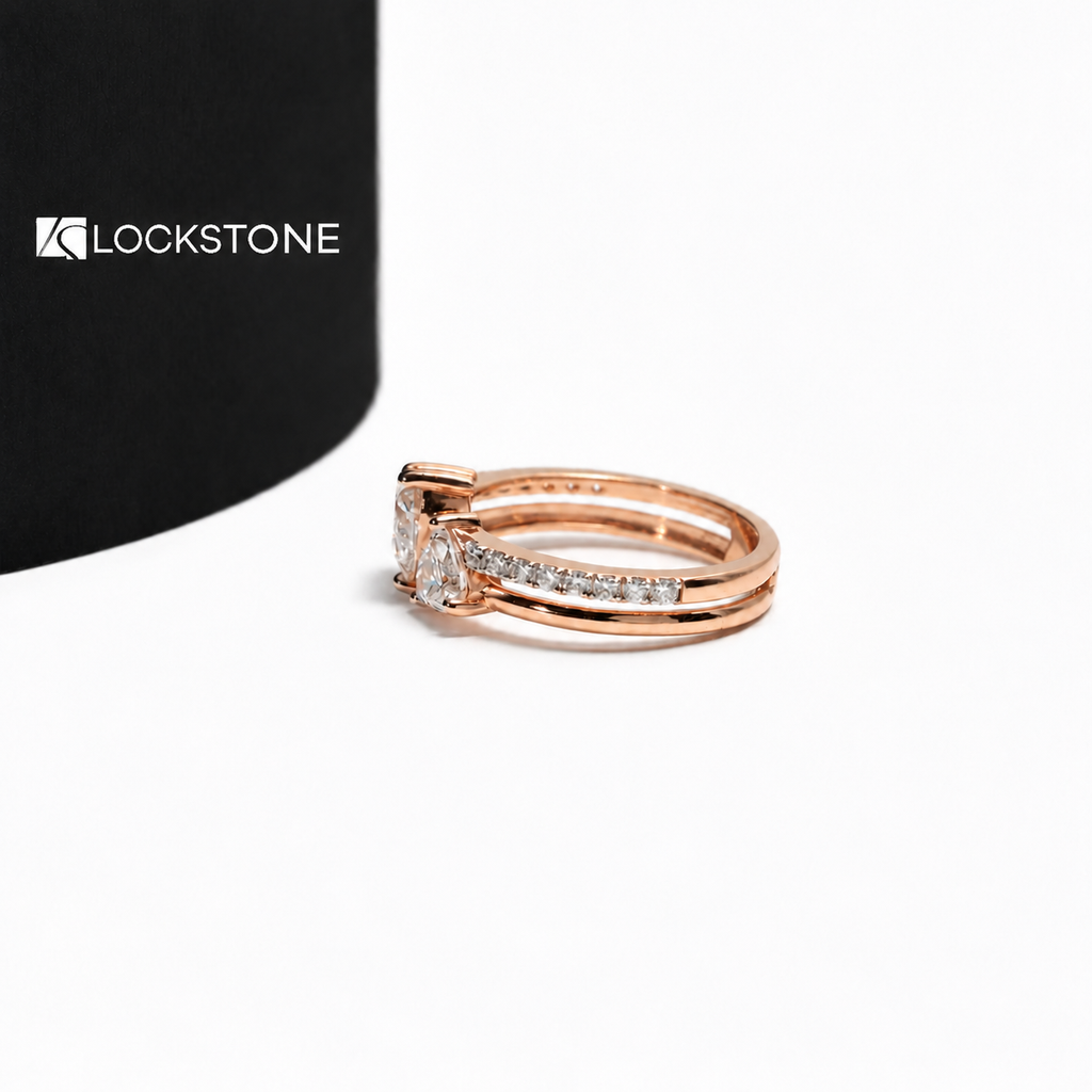 Two heart shaped lab diamonds sit side by side on this rose gold engagement ring paired with a diamond accented stacking band