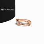 Two heart shaped lab diamonds sit side by side on this rose gold engagement ring paired with a diamond accented stacking band