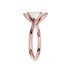 Rose gold ring with a clear gemstone on a white background