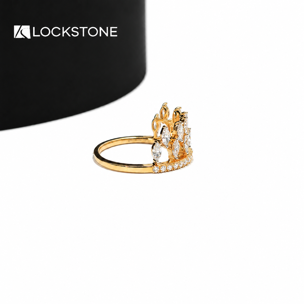 Marquise shaped diamonds form a pointed tiara pattern on this yellow gold statement ring with small round diamond accents