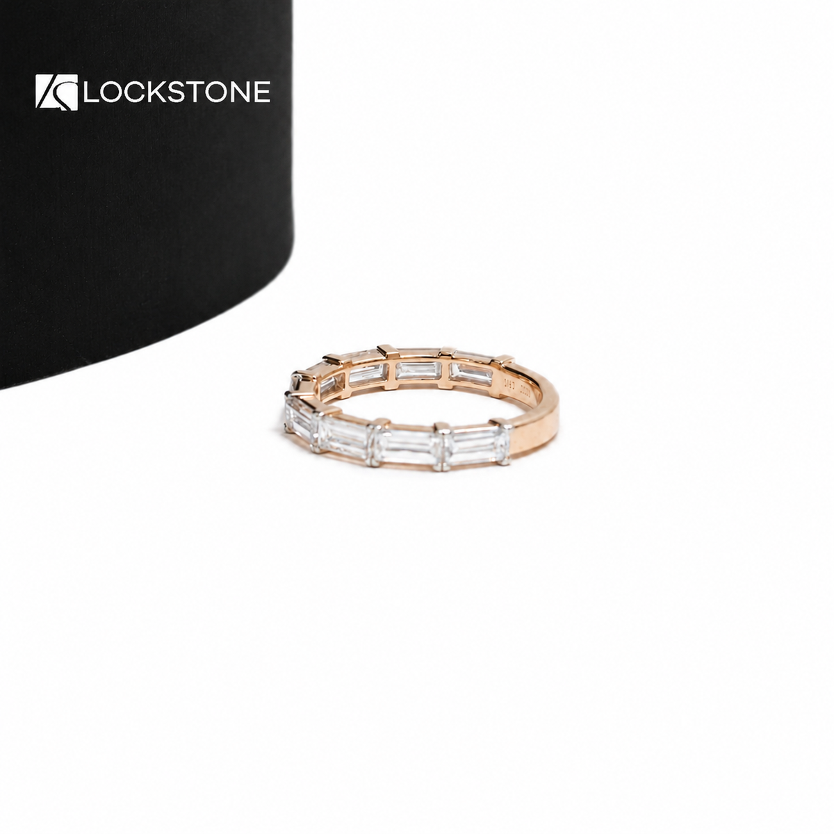 Rectangular lab grown diamonds sit side by side across a rose gold half eternity band with individual metal prongs