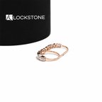 Heart shaped and rectangular emerald cut diamonds alternate with round stones across this rose gold anniversary ring
