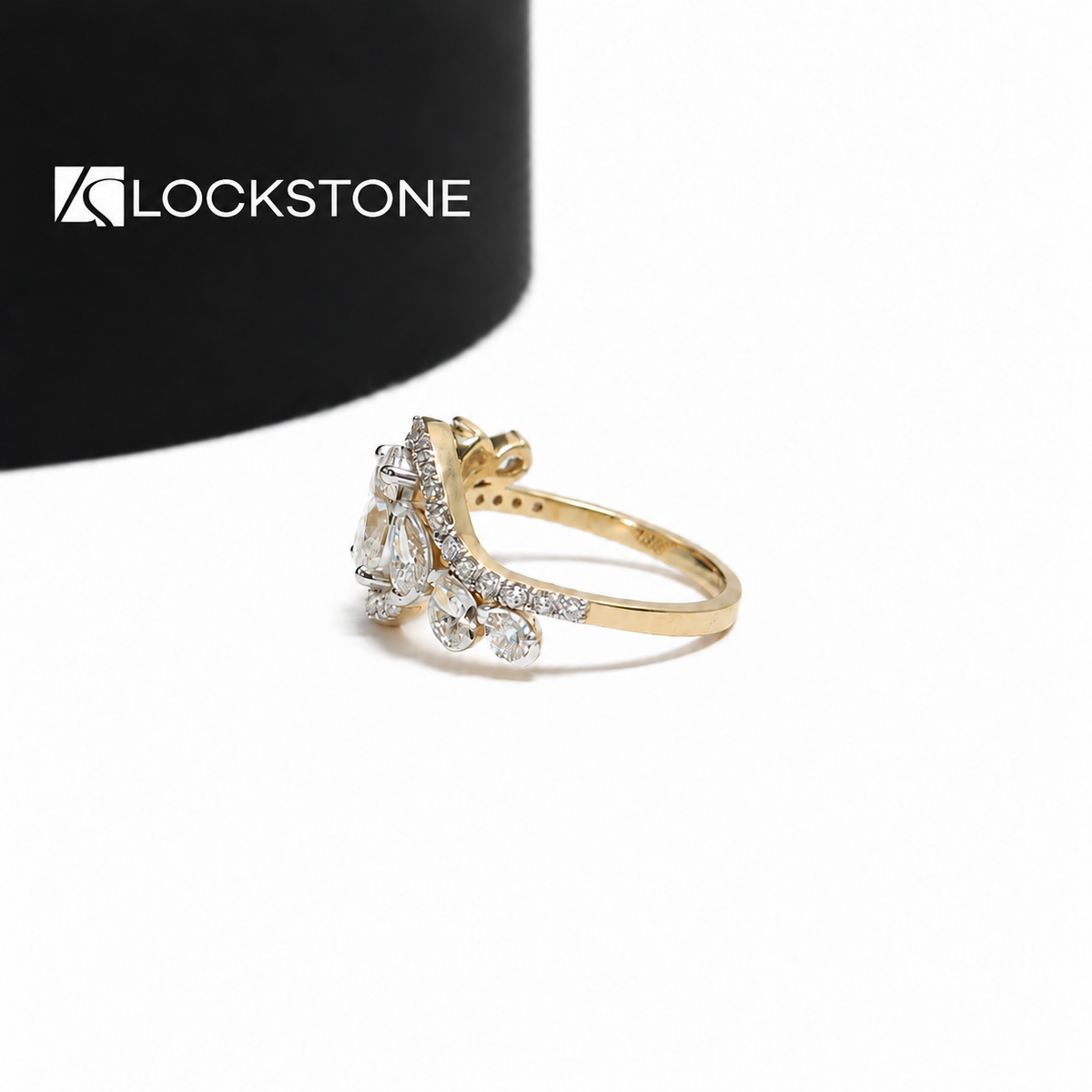 Five stone oval lab diamond engagement ring in yellow gold showcasing an open crossover design with round pavé accents