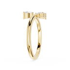 A polished yellow gold ring with a double-band design and two small clear gemstones at the top, shown on a plain white background.