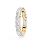 A yellow gold eternity ring paved with square-cut clear diamonds, shown on a clean white background.
