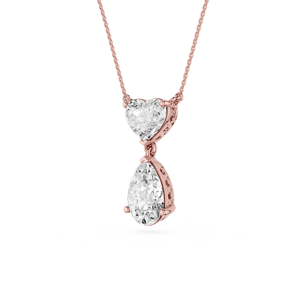 Rose gold necklace with heart and teardrop diamond pendants on a white background