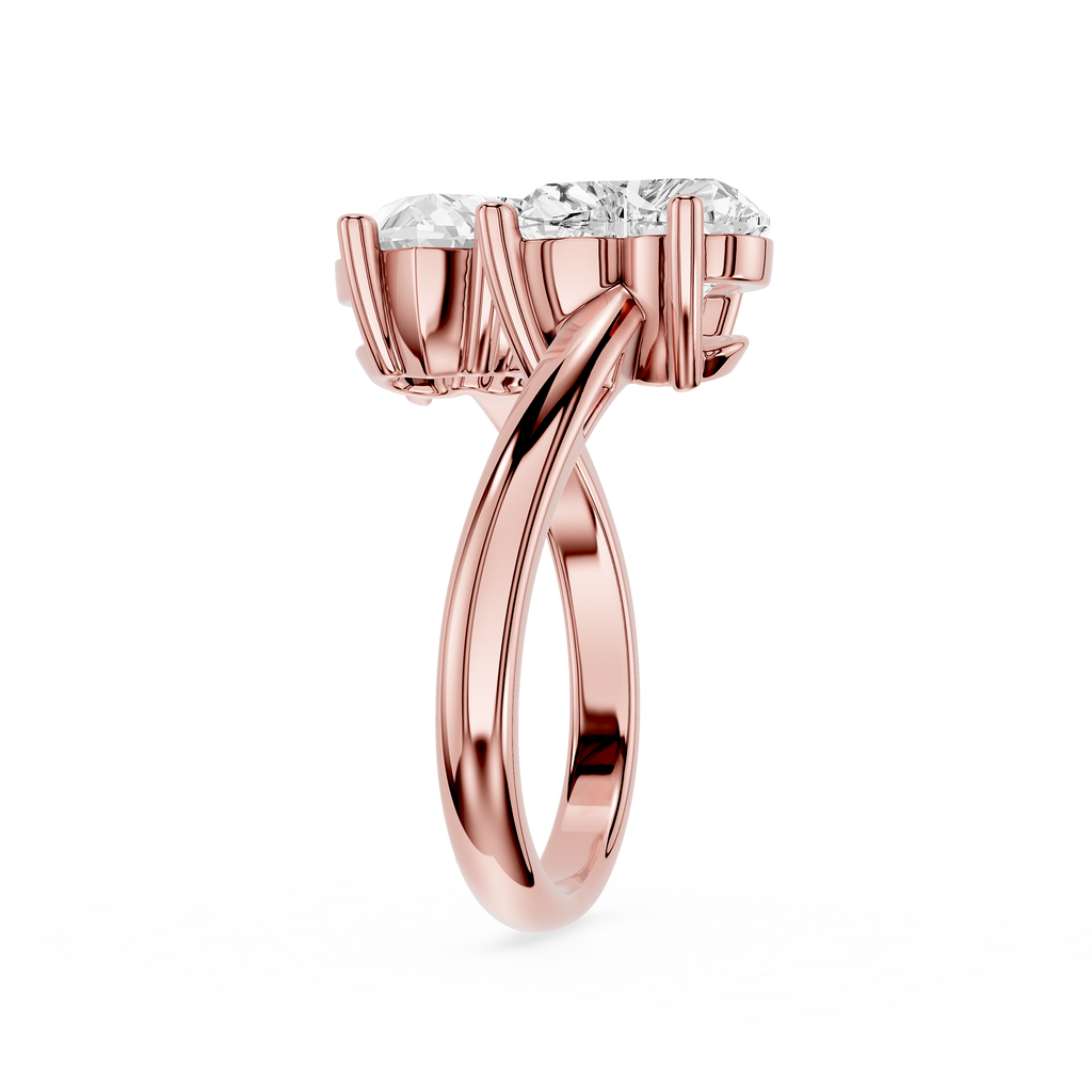 A rose gold diamond ring with a split-shank band and a three-stone crown, shown on a clean white background.