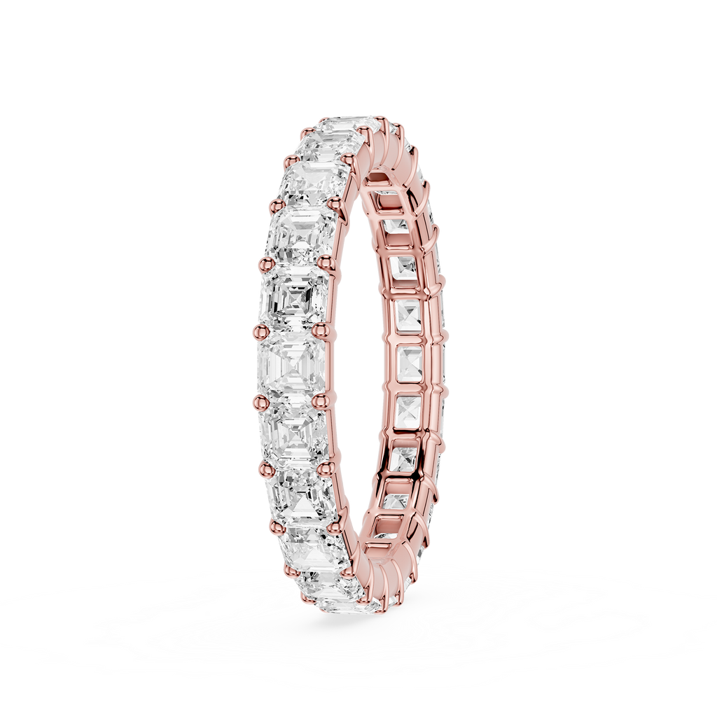 A rose gold eternity ring featuring a continuous row of clear baguette-cut gemstones, shown on a clean white background.