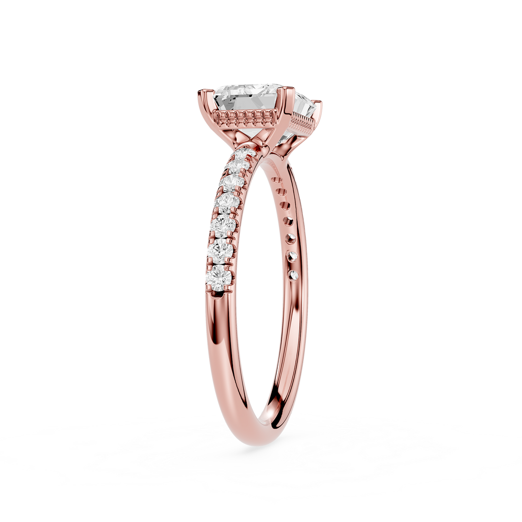 A rose gold engagement ring featuring a rectangular emerald-cut clear center stone and pavé-set round diamonds along the shank, shown on a clean white background.