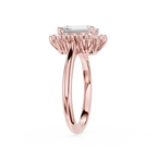 A rose gold halo ring featuring a rectangular baguette-cut clear gemstone, displayed on a clean white background.