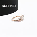 Pear diamond bow engagement ring in rose gold showcasing a prong set center stone and intertwined diamond lined shoulders