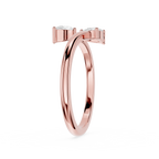 A rose gold ring with a double-band design and small clear gemstones on the top, shown on a plain white background.