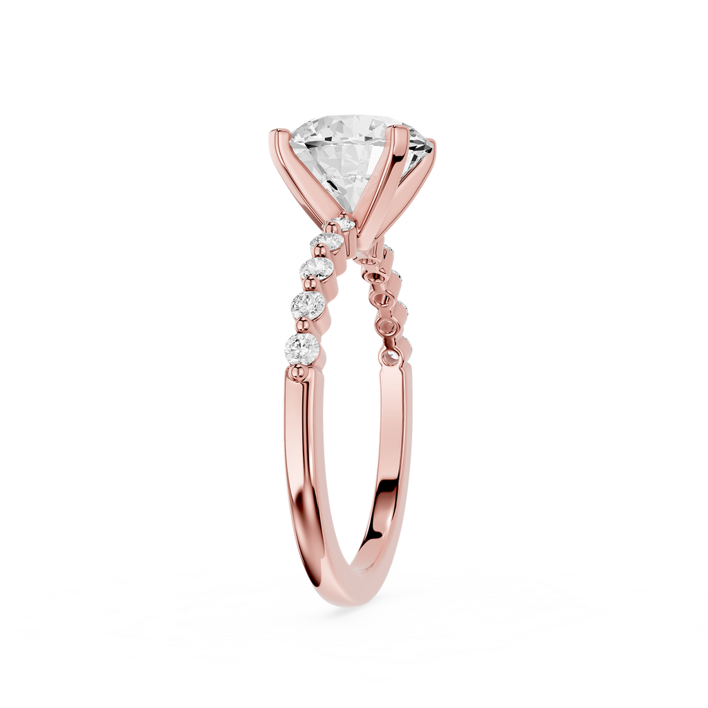 A rose gold engagement ring featuring a large pear-cut diamond center stone and a pavé band with small round diamonds, shown on a clean white background.
