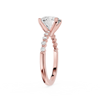 A rose gold engagement ring featuring a large pear-cut diamond center stone and a pavé band with small round diamonds, shown on a clean white background.