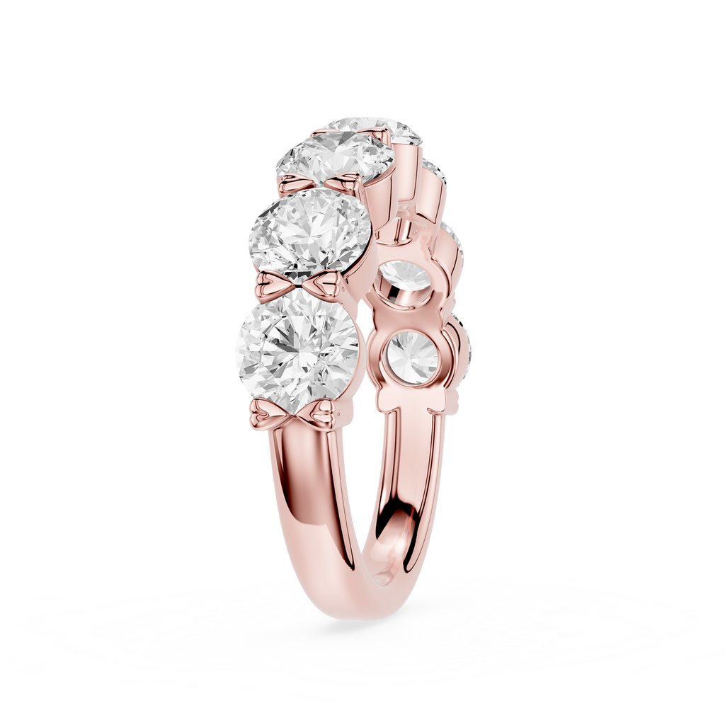 A silver-tone diamond ring featuring three large round-cut diamonds in a row with three smaller diamonds on the side, set against a plain white background.