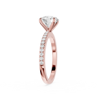 A rose gold diamond ring with a large round-cut center stone and a pavé band of small round diamonds, shown on a clean white background.