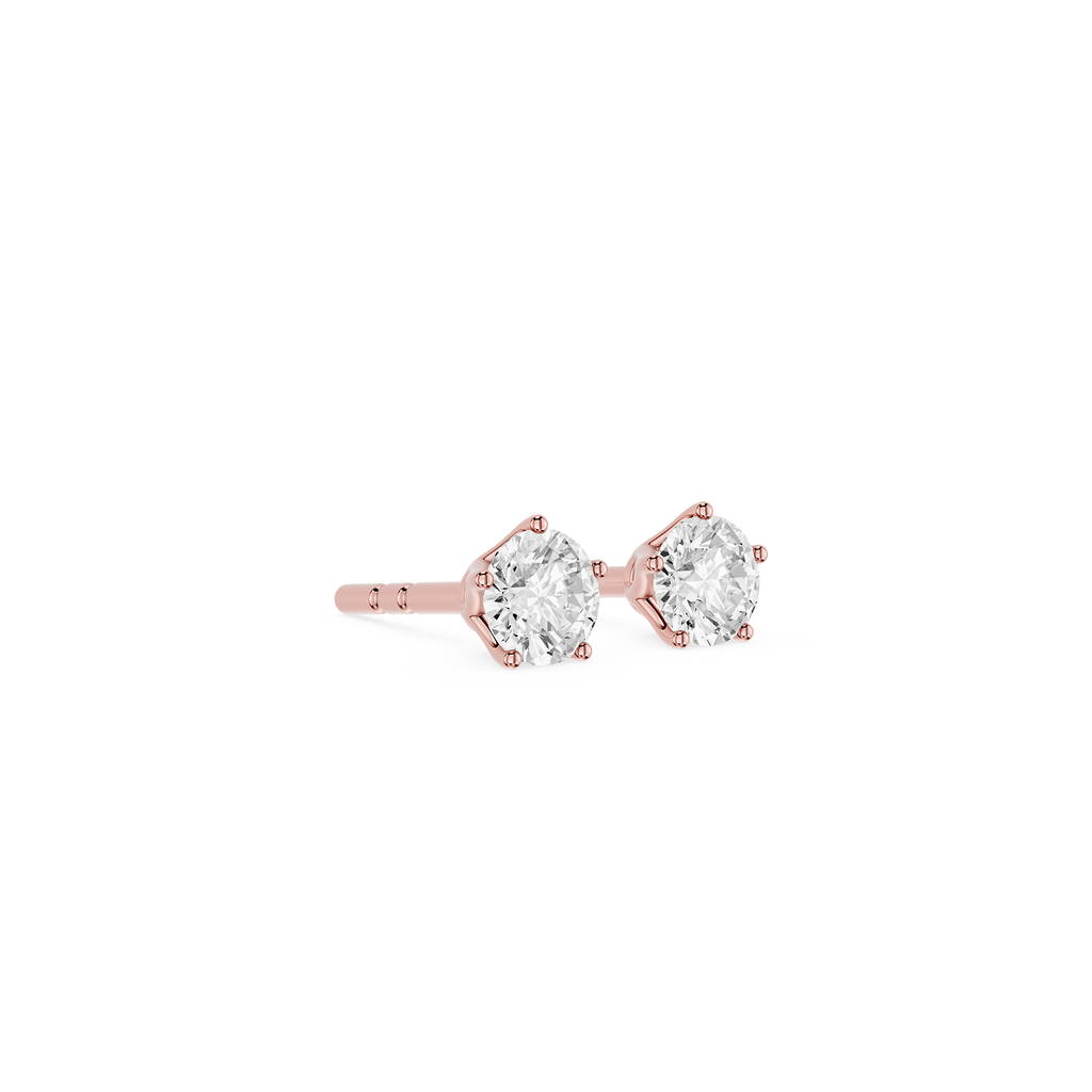 Rose gold earrings with clear gemstones on a white background