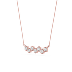 Rose gold necklace with clear gemstones on a white background