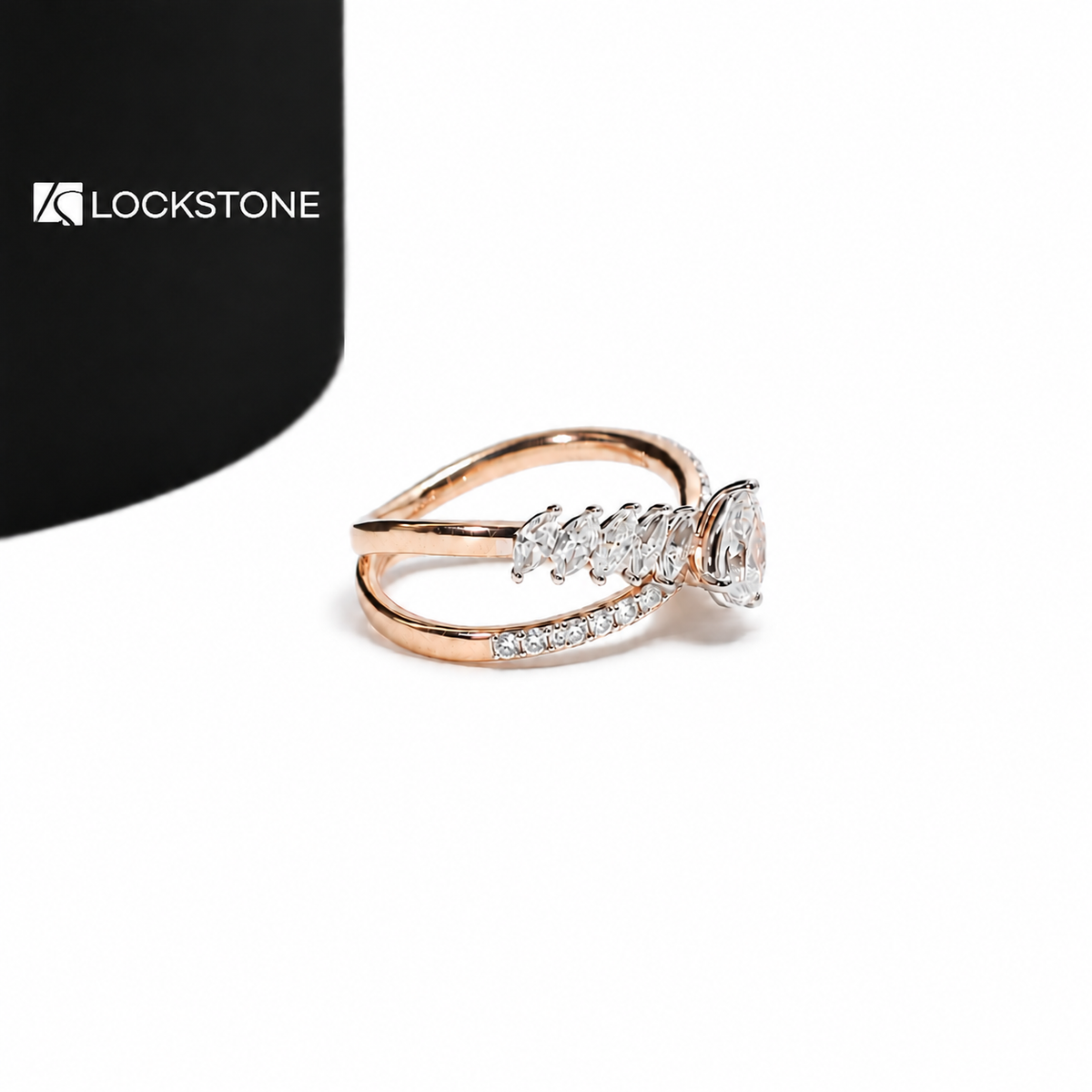 An oval cut diamond sits between graduated marquise diamonds on this rose gold crossover ring with curved pavé bands