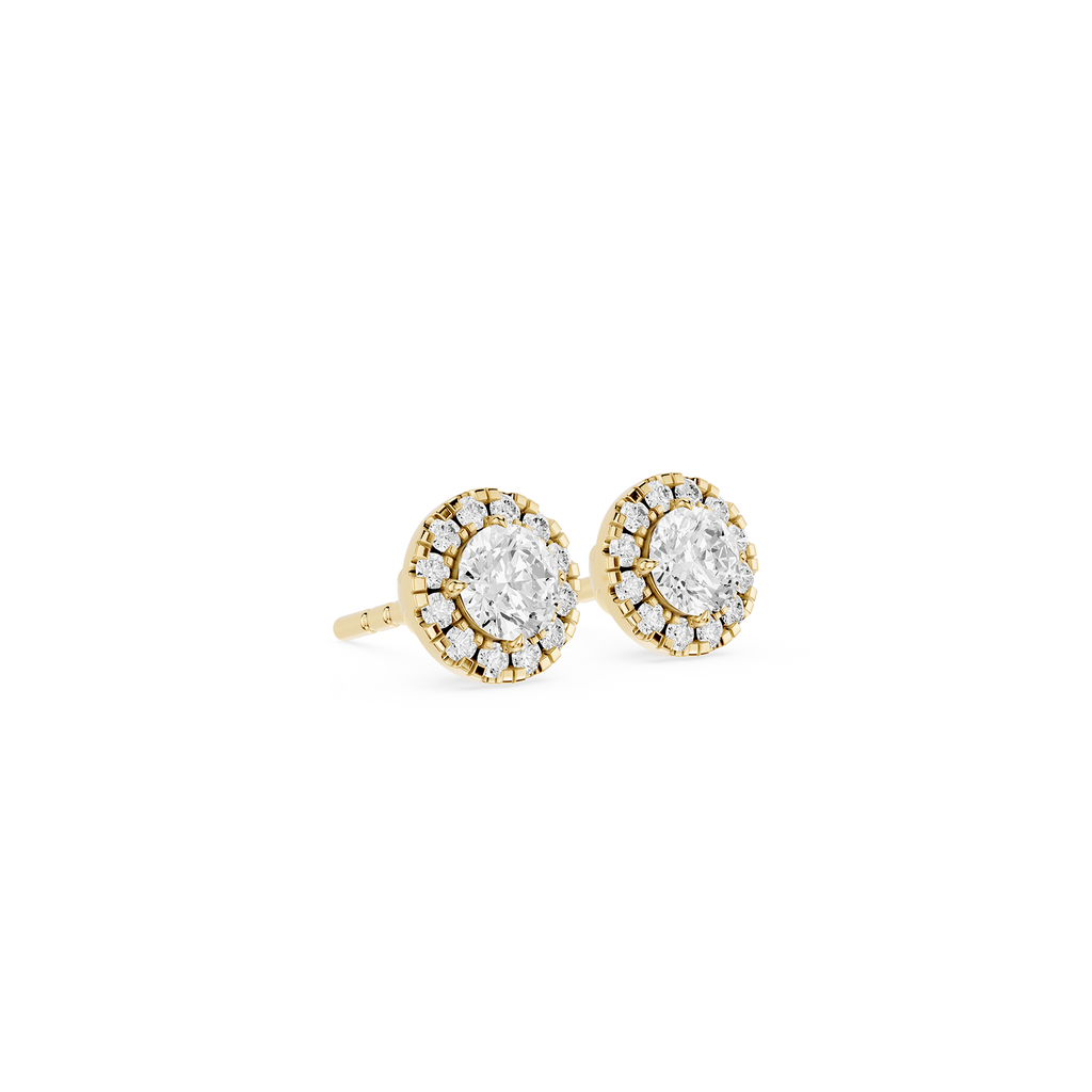 Gold earrings with clear gemstones on a white background