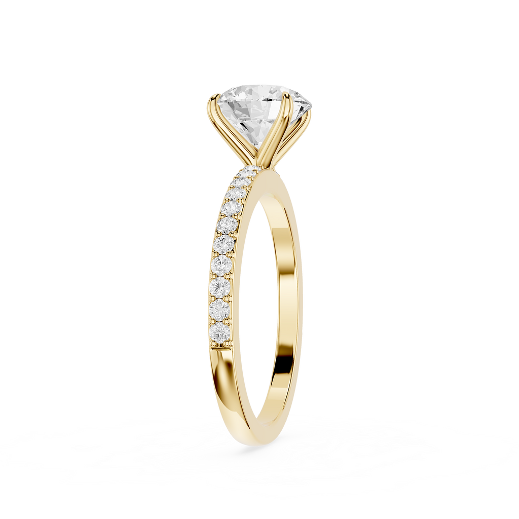 A yellow gold solitaire engagement ring featuring a large round brilliant-cut diamond center stone and a pavé band with small round diamonds, shown on a plain white background.