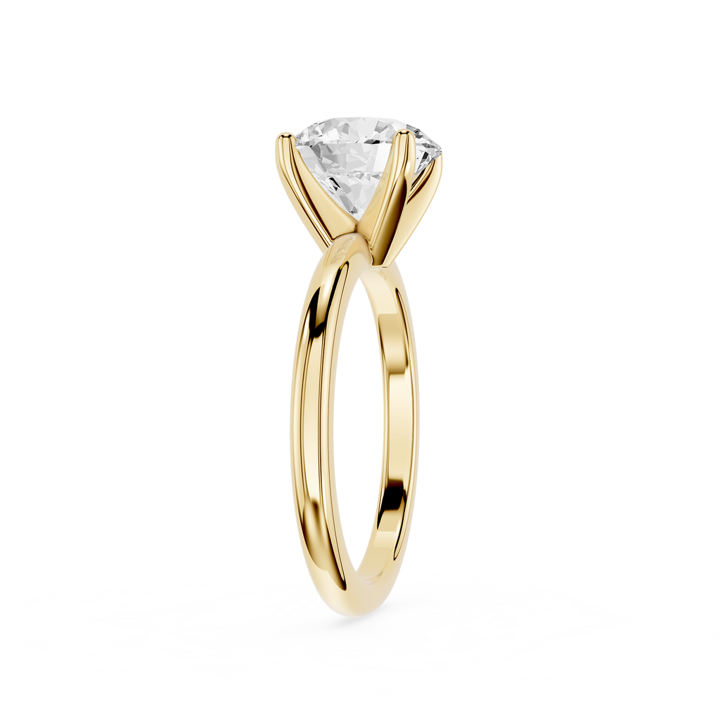 Gold ring with a clear gemstone on a white background