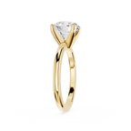 Gold ring with a clear gemstone on a white background