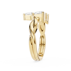 Gold ring with a twisted design on a white background