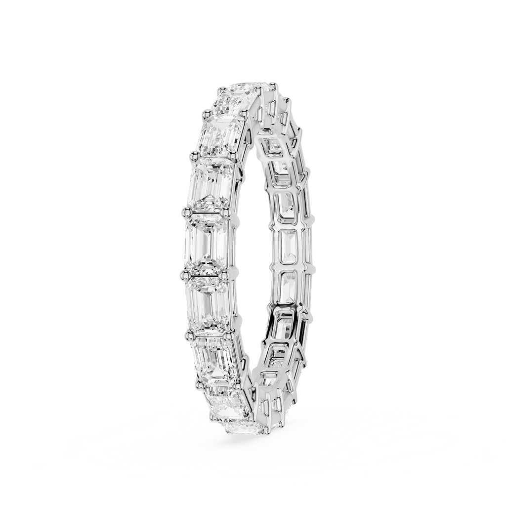 A silver-toned eternity band ring featuring a continuous row of baguette-cut clear gemstones, shown on a plain white background.