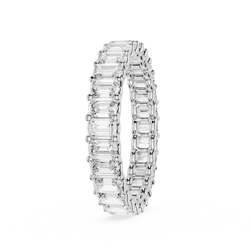 A silver-toned eternity ring featuring a continuous row of baguette-cut clear gemstones, shown on a clean white background.