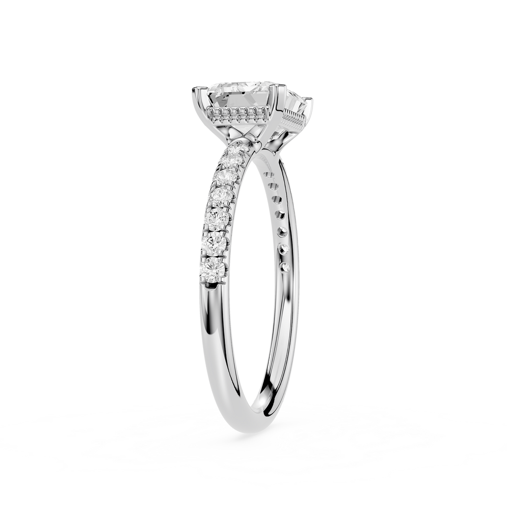 A silver-toned diamond engagement ring with a round center stone and a pavé band, shown on a plain white background.