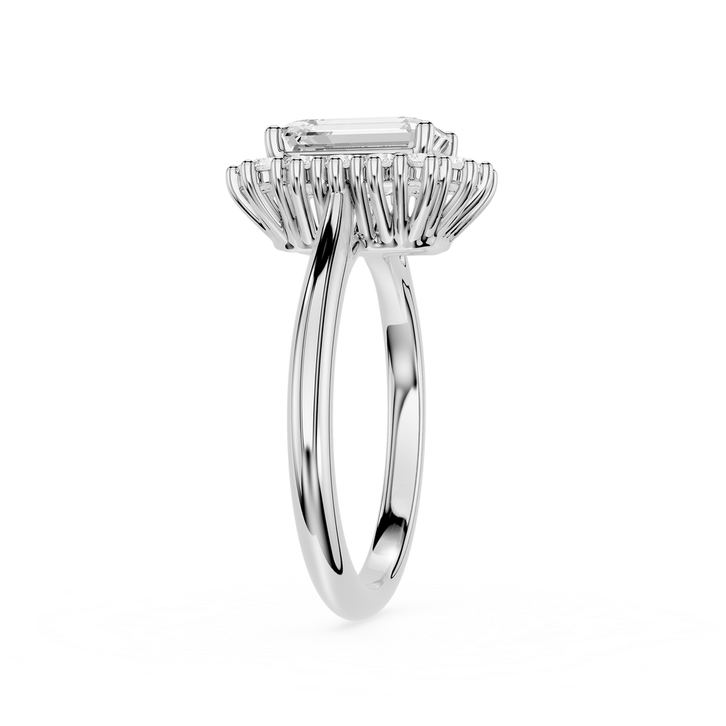 A silver-toned halo ring featuring a rectangular emerald-cut center stone and a surrounding cluster of smaller stones, shown on a plain white background.