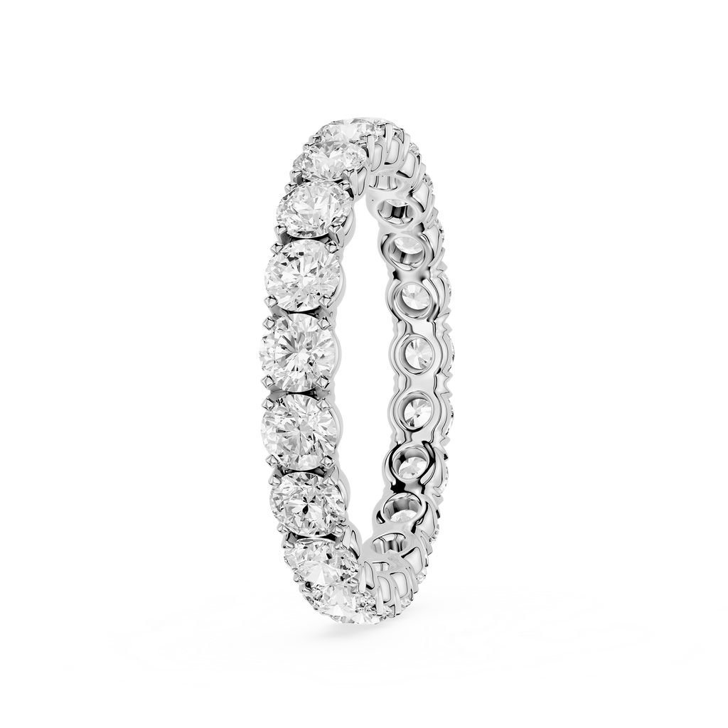 A silver-toned eternity ring featuring a continuous row of round-cut clear gemstones in a prong setting, shown on a plain white background.