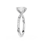 A silver solitaire engagement ring featuring a triangular-cut clear gemstone in a four-prong setting, with a polished band accented by small pavé-set round diamonds, shown on a plain white background.