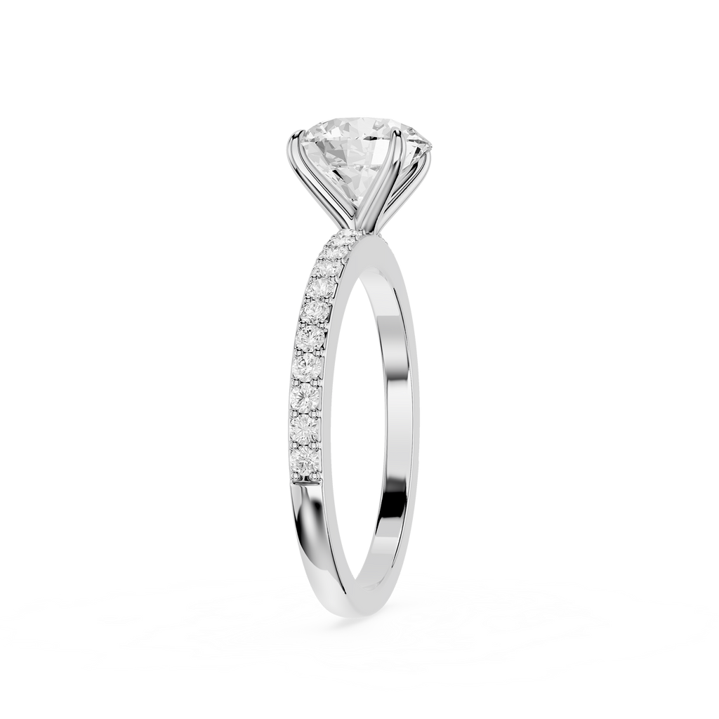 A silver-tone solitaire engagement ring featuring a round brilliant-cut diamond center stone and a pavé-set diamond band, shown on a clean white background.