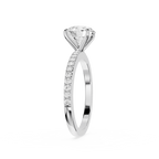 A silver-tone solitaire engagement ring featuring a round brilliant-cut diamond center stone and a pavé-set diamond band, shown on a clean white background.