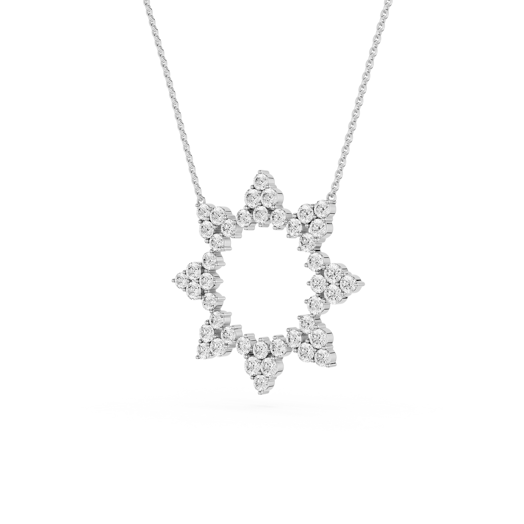 Star-shaped diamond pendant on a chain against a white background