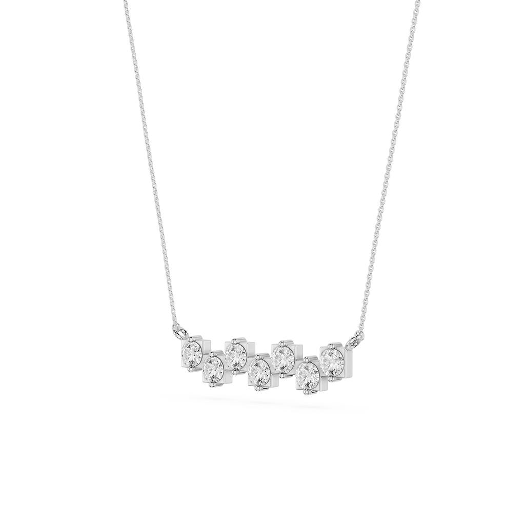 Silver necklace with five round diamonds on a white background