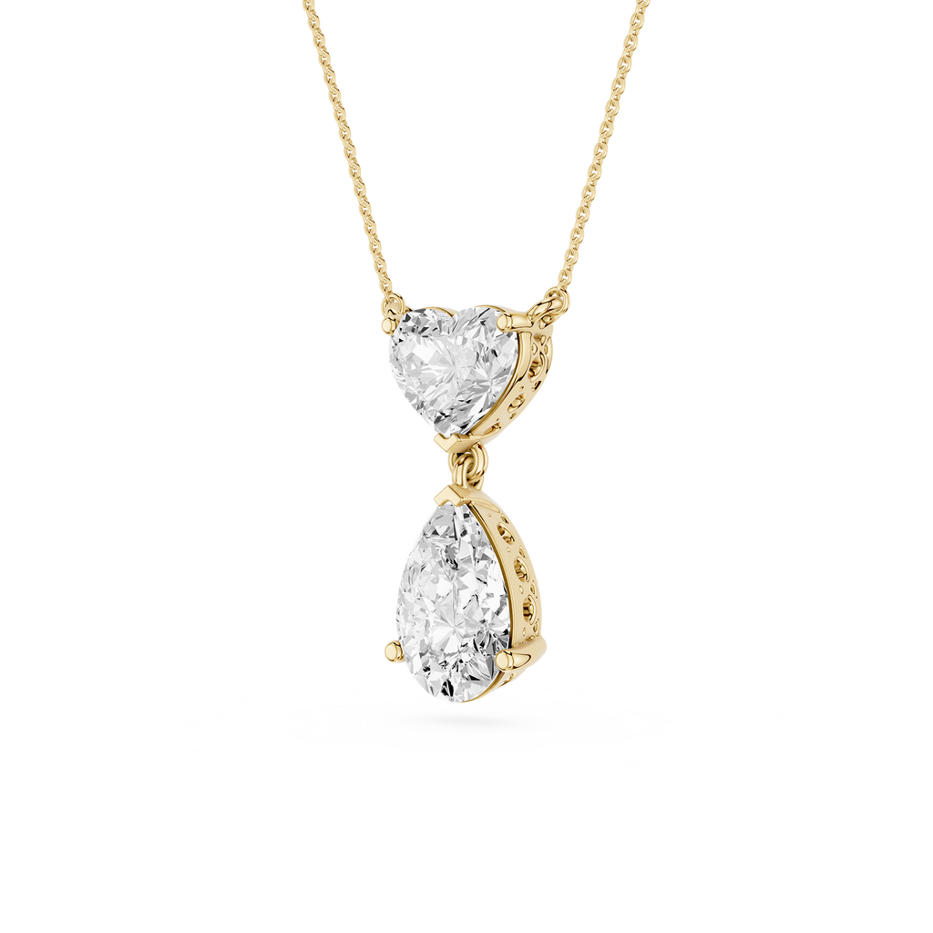 Gold necklace with heart and teardrop-shaped diamond pendants on a white background