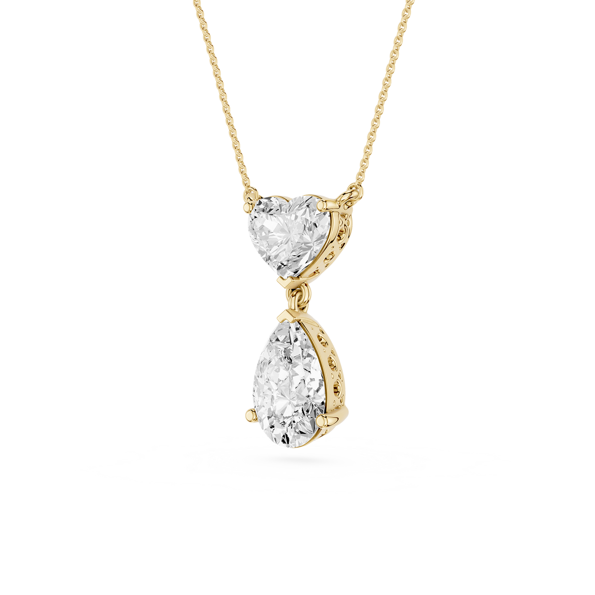 Gold necklace with heart and teardrop-shaped diamond pendants on a white background