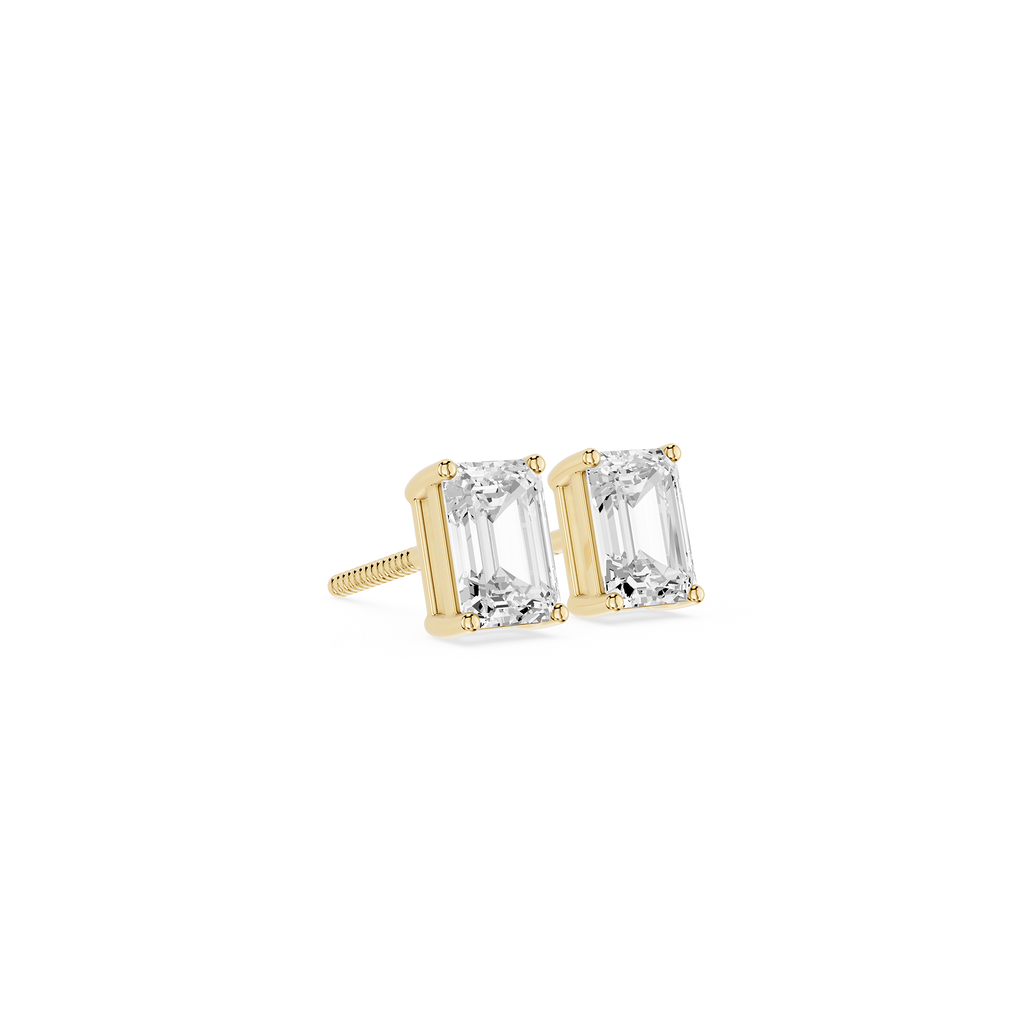 Gold earrings with clear gemstones on a white background